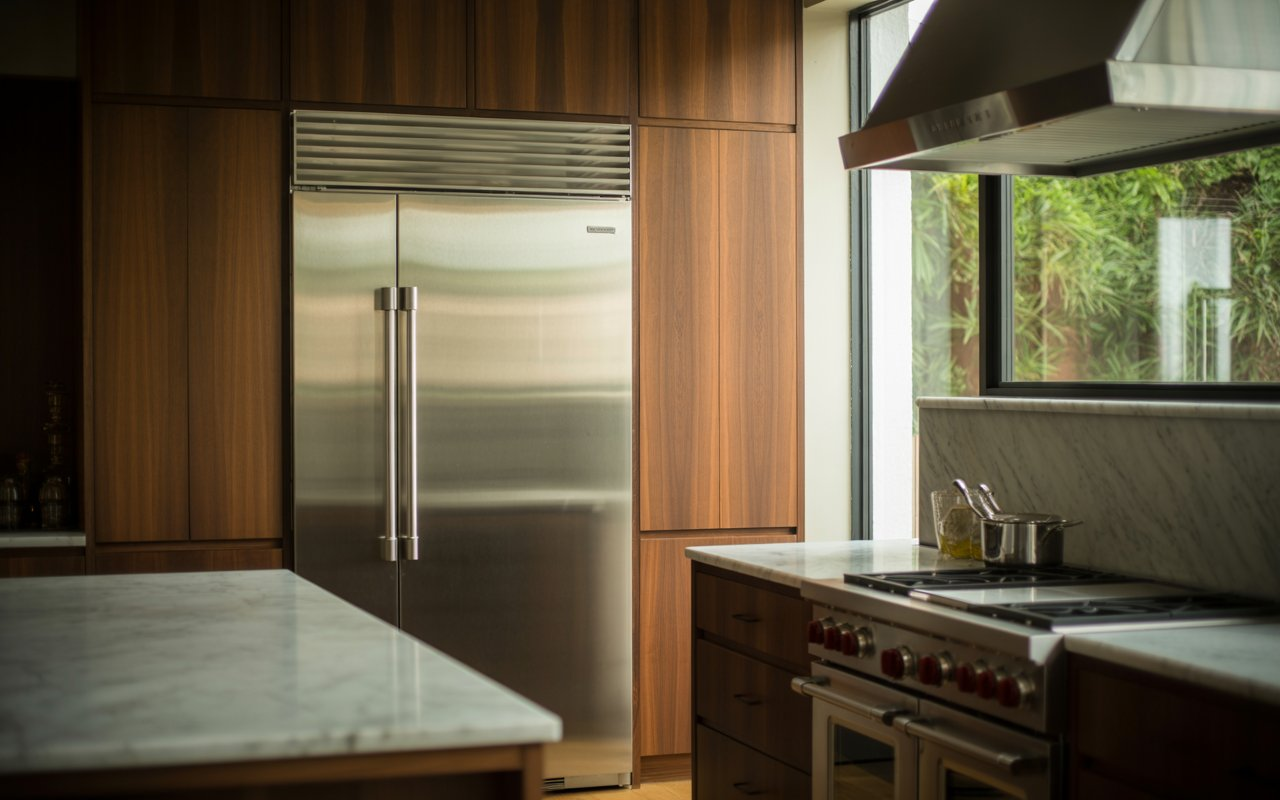 Built-in Sub-Zero refrigerator and Wolf range in luxury kitchen